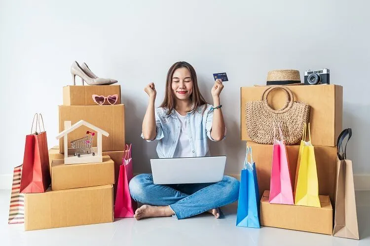 happy asian woman with colorful shopping bags cardboard boxes home