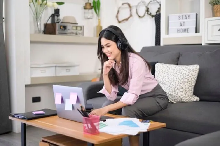 beautiful young woman wearing headset is making video conference call via computer home business technology concept 337998656 1