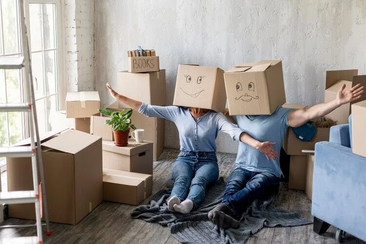 couple home moving day with boxes heads